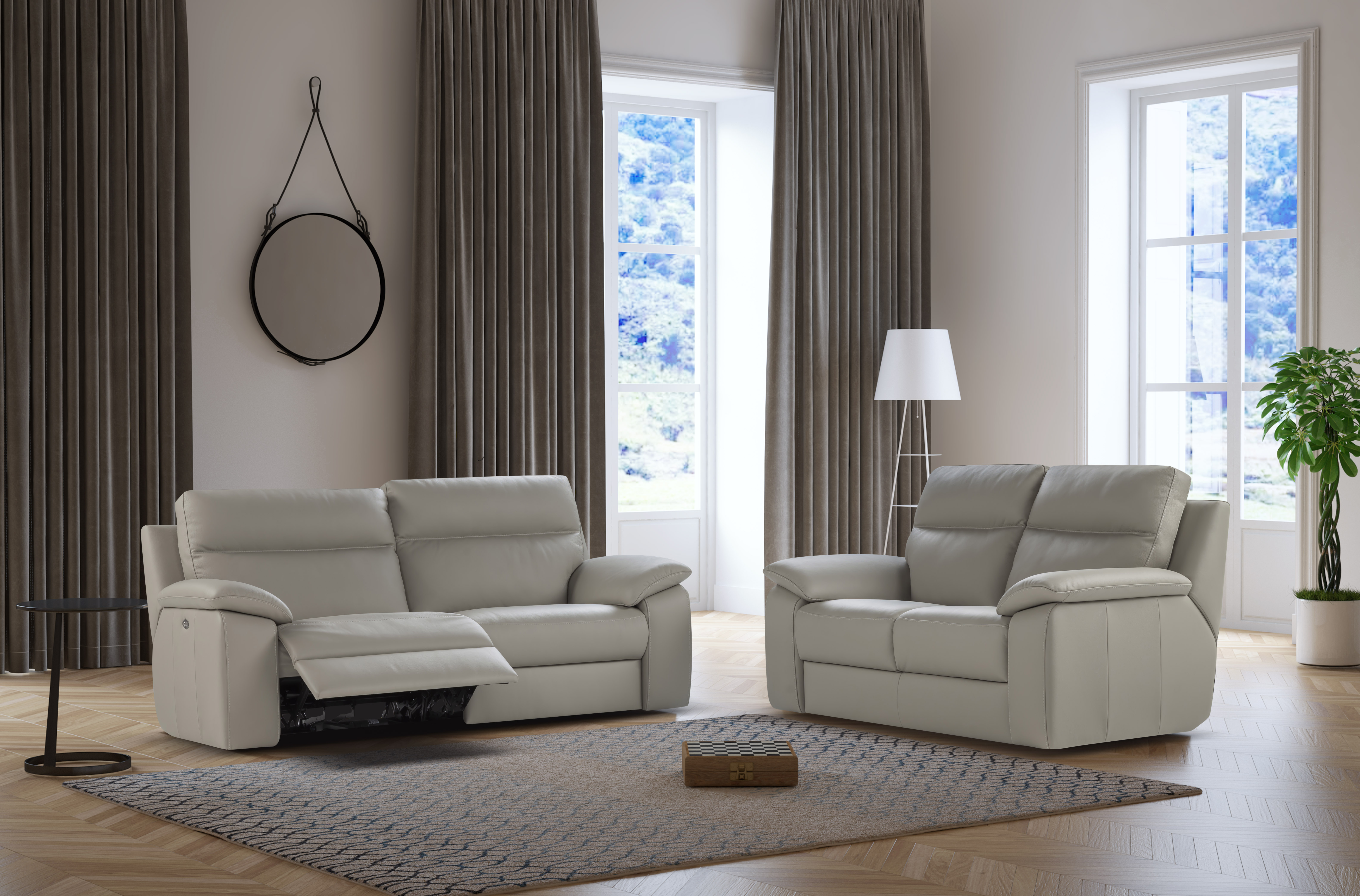 two nicoletti 2 seater recliner sofas in cream leather in a neutral living room