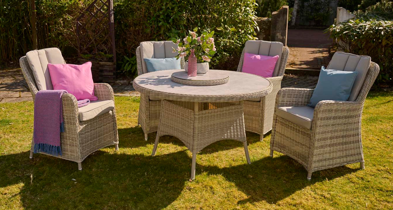 An image of the Eden 4 Seat Dining Set in a sunny, grassy garden setting.