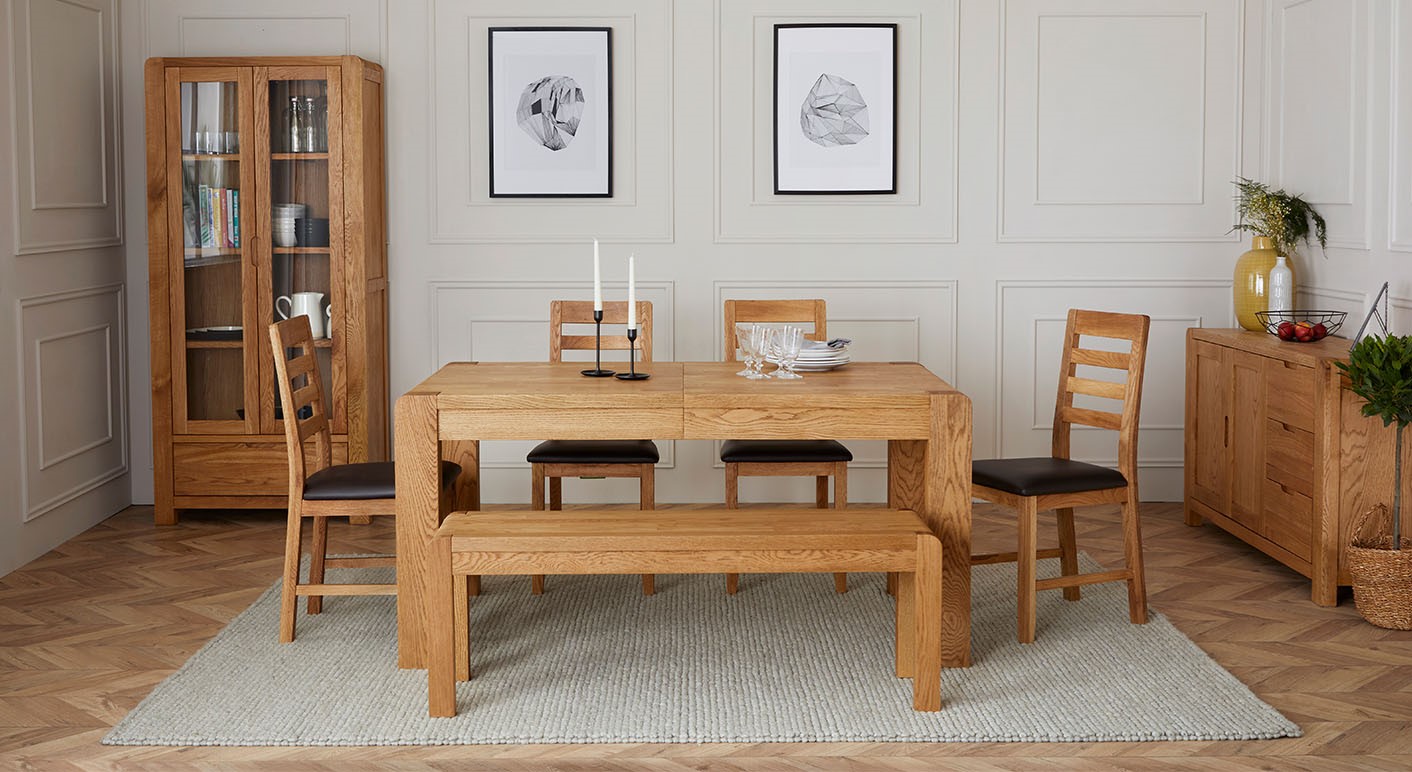 Solvi classing wooden dining set matched with matching wooden sideboard and cabinet in a neutral dining room