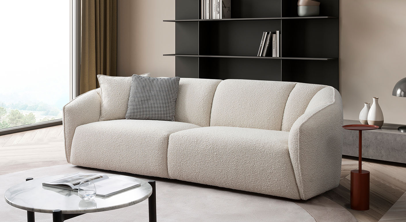 Flynn 2 Seater Sofa in white boucle in a light livingroom with black bookcase behind