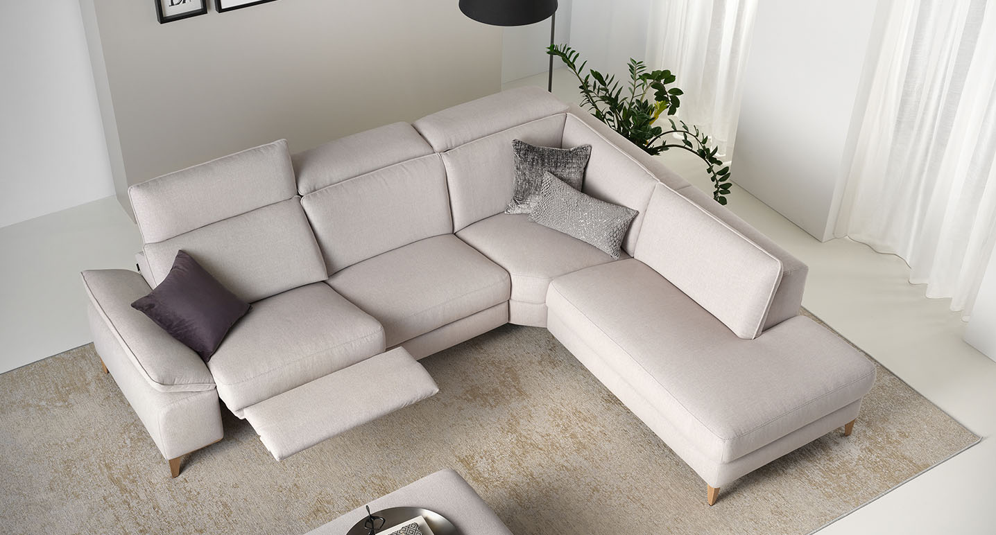 birds eye view of rom cream corner sofa in a bright neutral room styled with grey and purple cushions