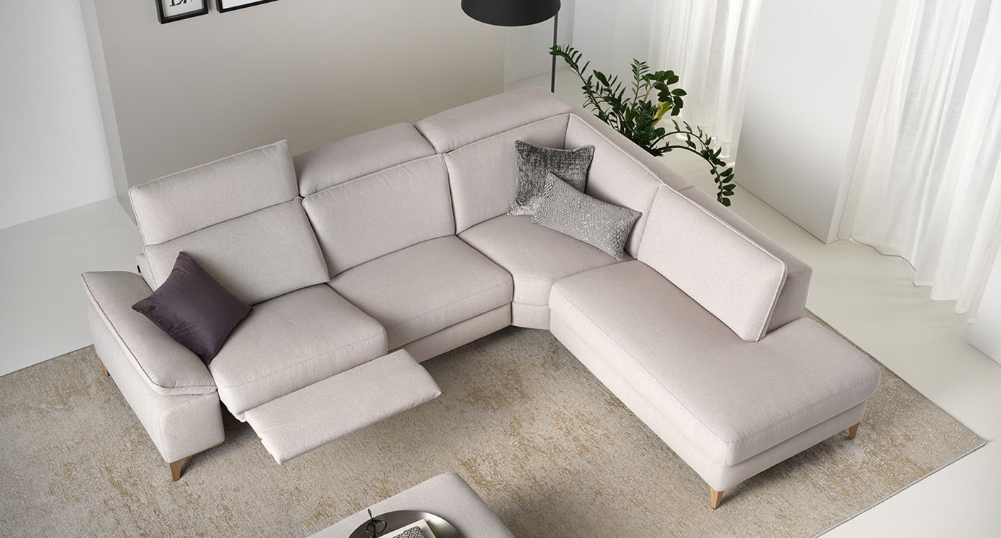 birds eye view of rom cream corner sofa in a bright neutral room styled with grey and purple cushions