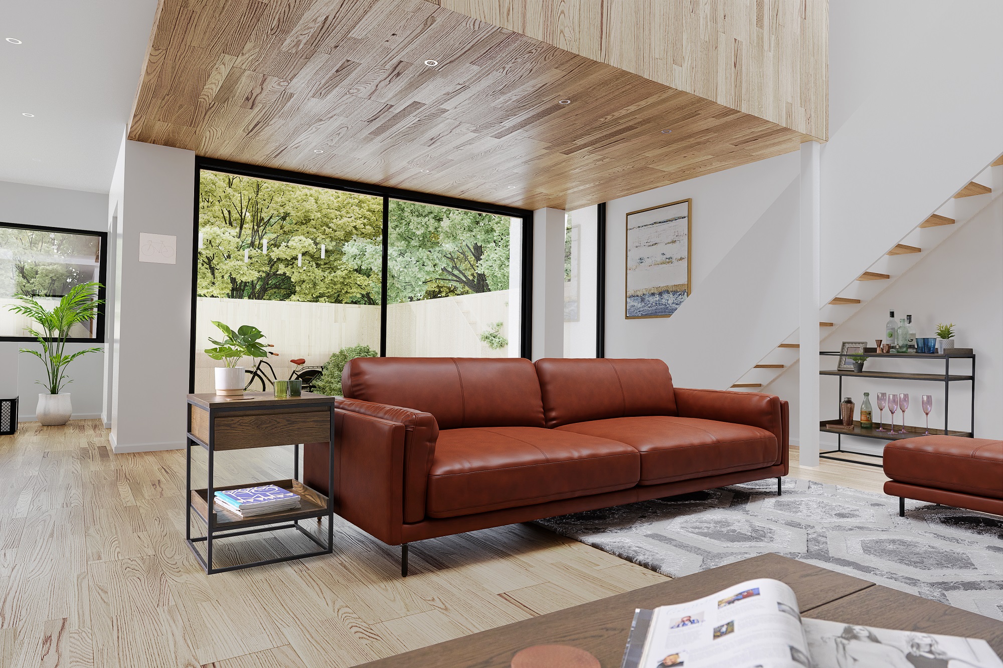 Industrial styled brown leather sofa with metal legs sitting in a living room with wooden floors