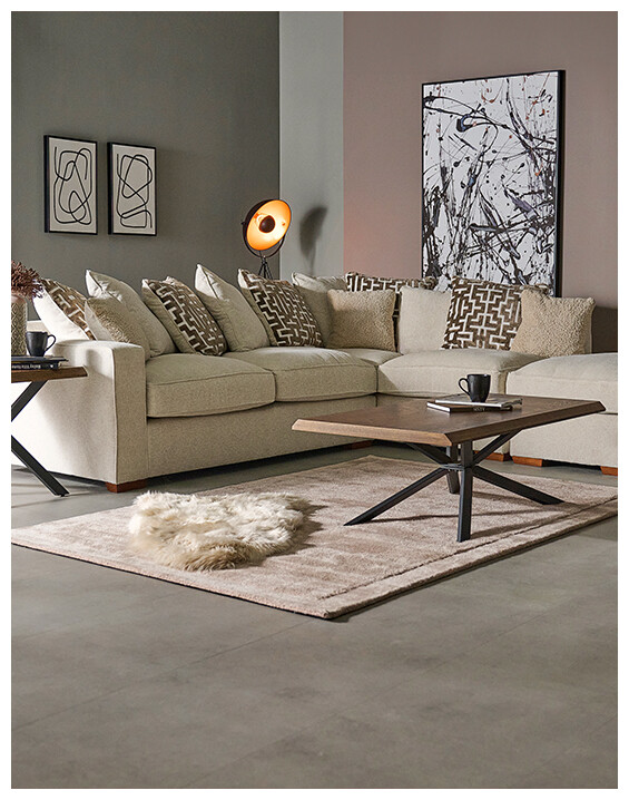 An image of the Hope Corner Sofa in a cream fabric, styled in a modern neutral-toned living room.