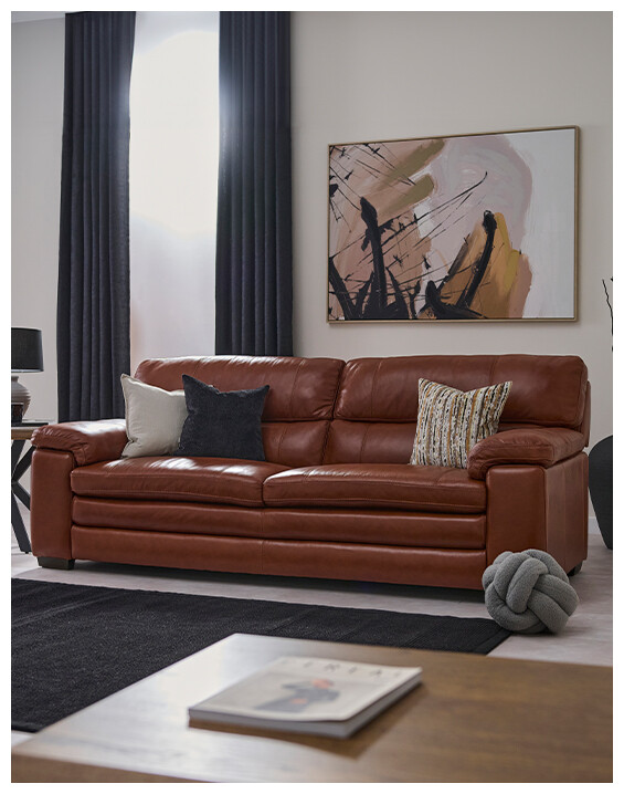 An image of the Stanton 3 Seater Sofa in brown leather, in a modern living space.