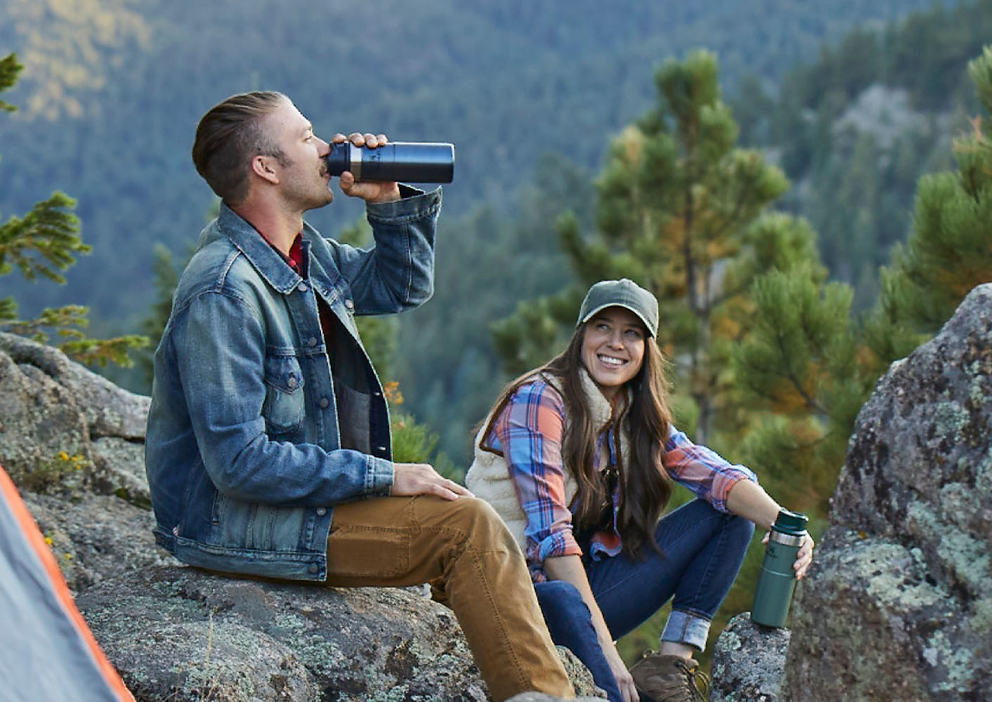 Scenic photo with 2 people drinking from stanley bottles