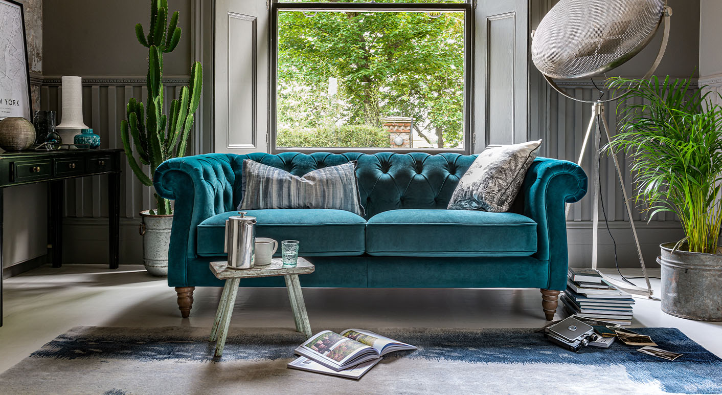 Camden 2 seater sofa in teal velvet on a blue rug