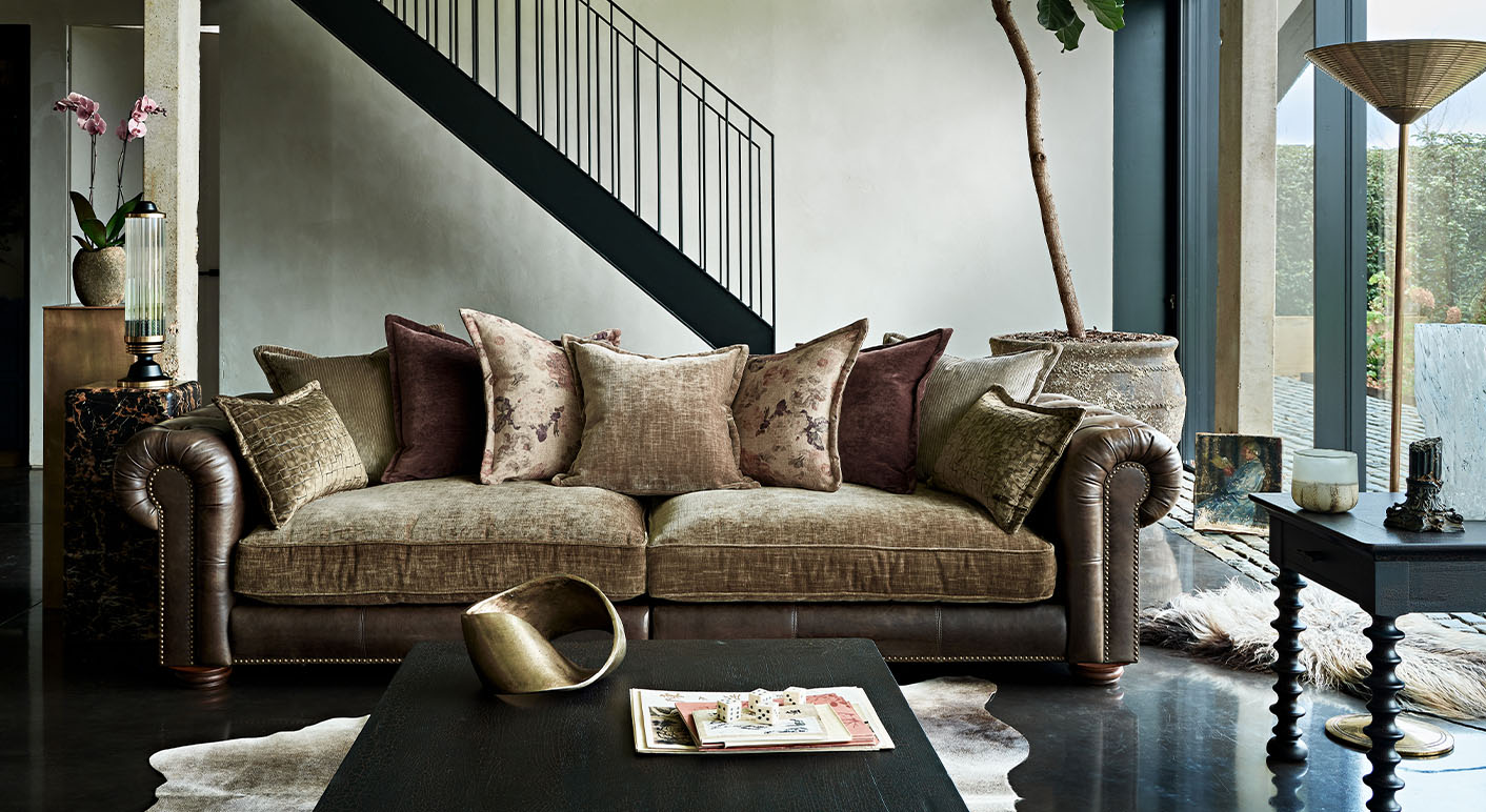 Atlantis brown leather and fabric mix 2 seater sofa in a bright room with floor to ceiling windows