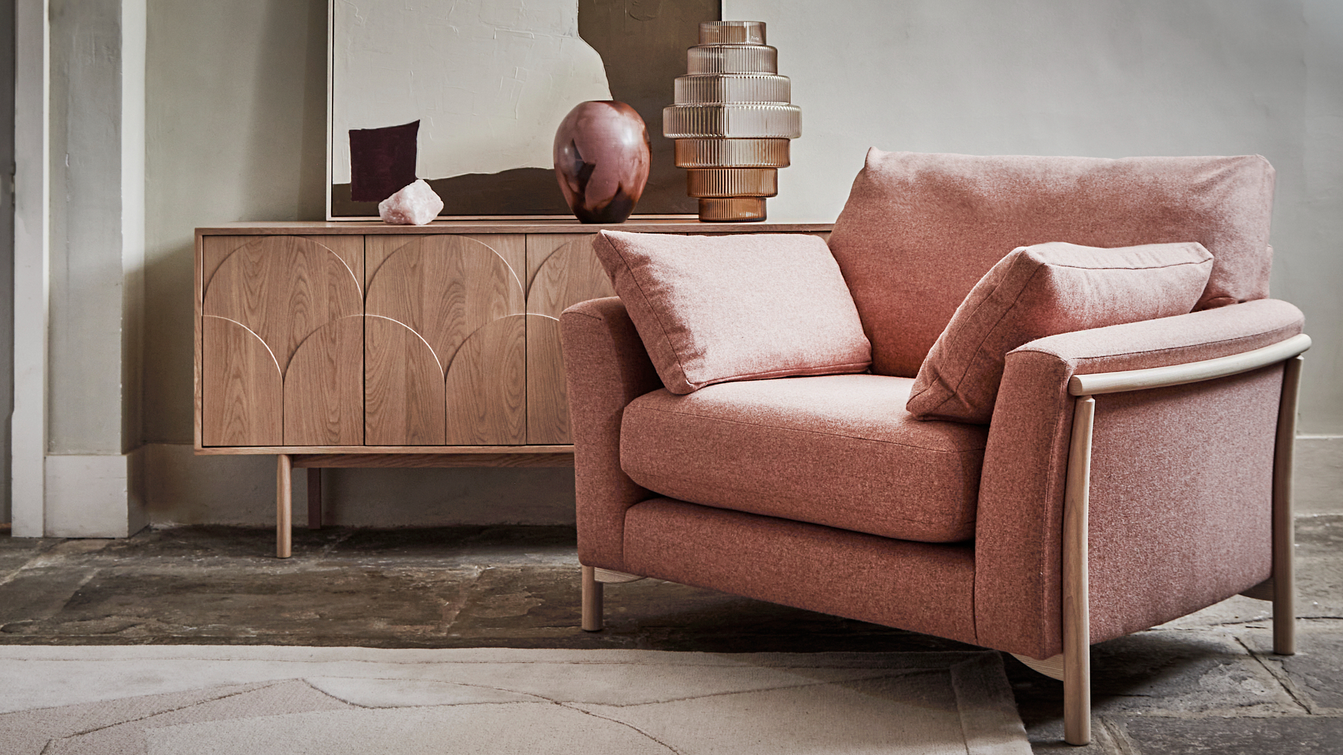 Ercol Avanti Pink Fabric Armchair with Amalfi Sideboard in a Neutral Room