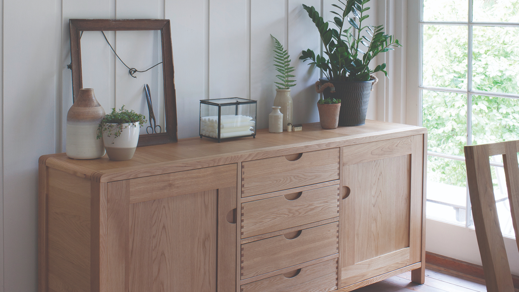 Ercol Bosco Large Oak Sideboard Displaying Plants, Vases and Decor 