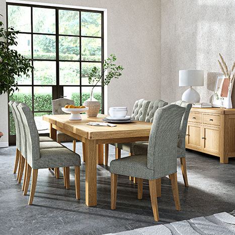 navarre solid oak dining set in a neutral dining room featuring the matching navarre sideboard