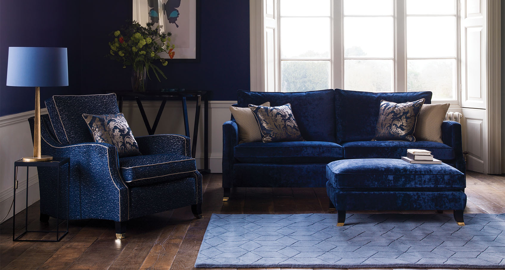 Amelia Duresta 2 seater sofa, armchair & footstool all in blue fabric in a blue decorated room