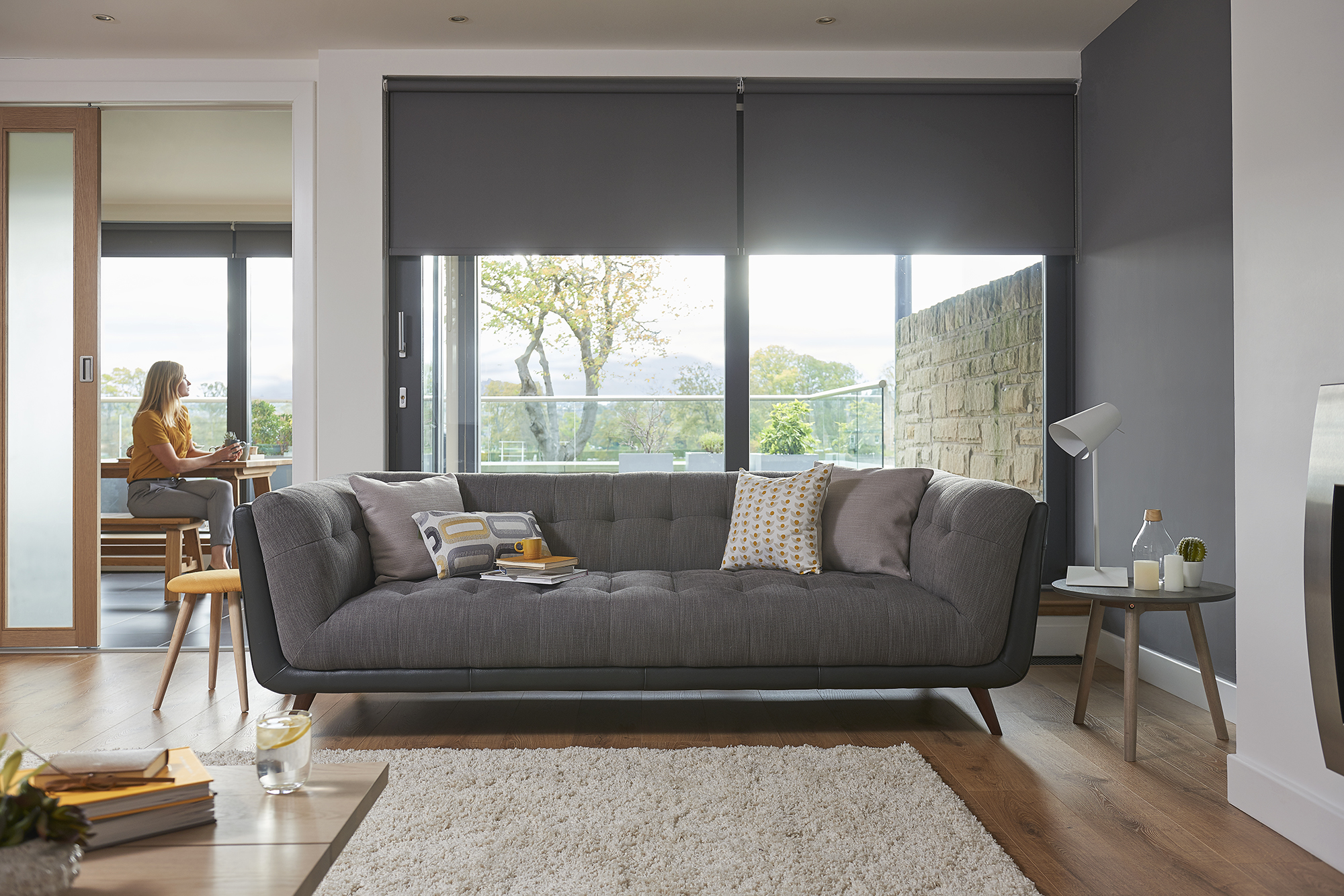 A mid century modern sofa in grey and black shown in a modern living room