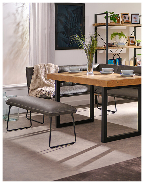 An image of the Marx Low Dining Bench at a wooden table.