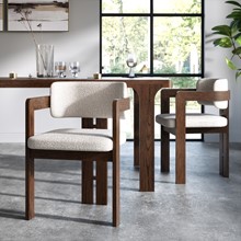 close up of the sonoma boucle and wooden dining chair in a stylish modern dining room