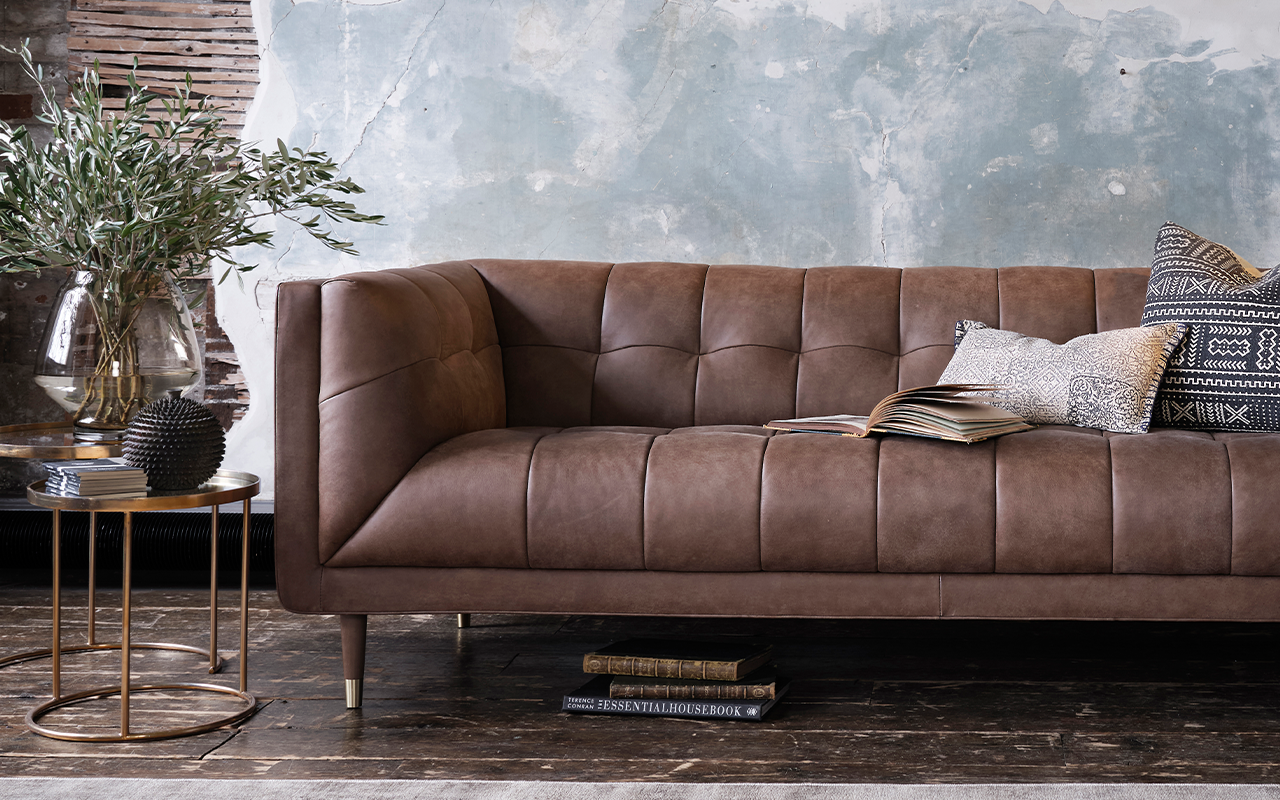 cassia brown leather grand sofa in dark setting
