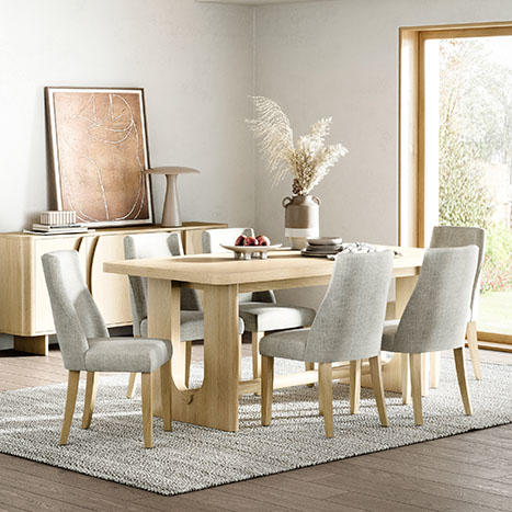 Camden light oak dining set featuring the matching sideboard in a bright neutral dining room